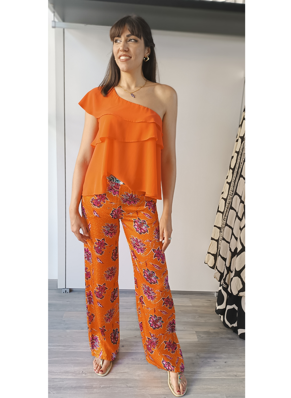 Pantaloni in fantasia floreale su fondo arancio